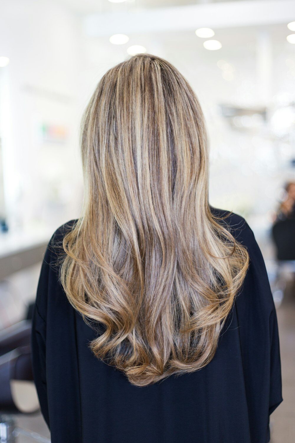 Long, softly waved blonde hair seen from behind