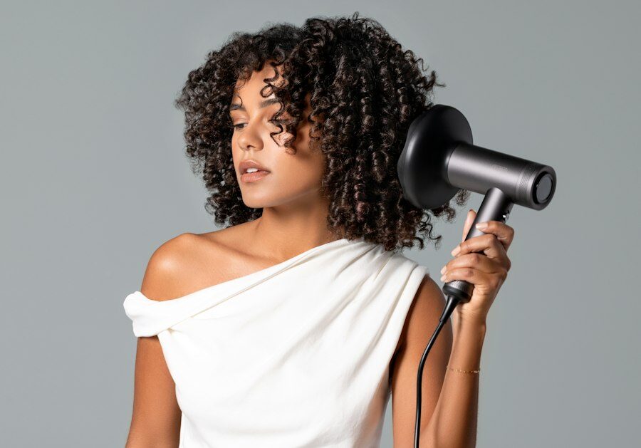 Woman diffusing her natural curls with a hairdryer