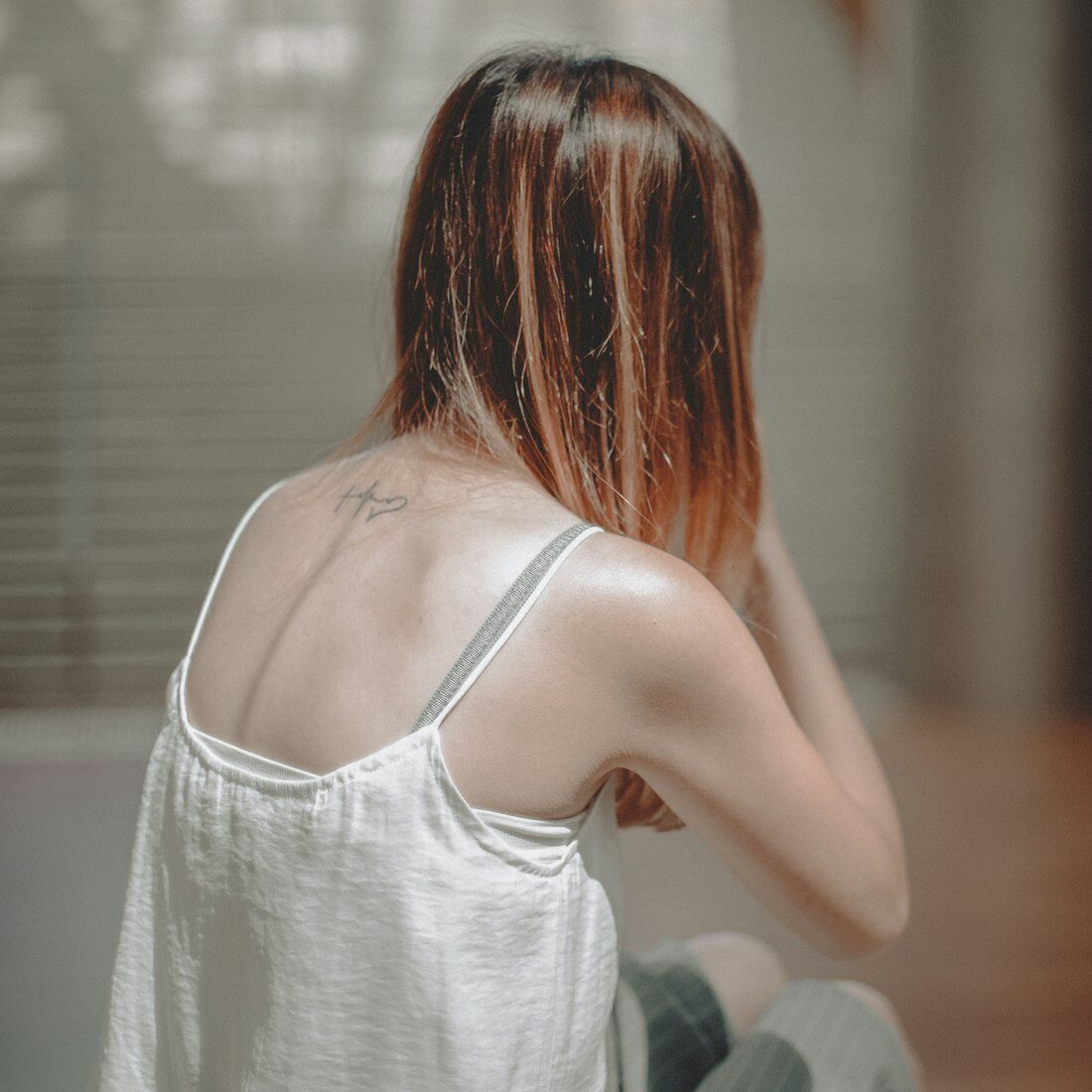 Shoulder-length hair with warm copper colour melting through the ends