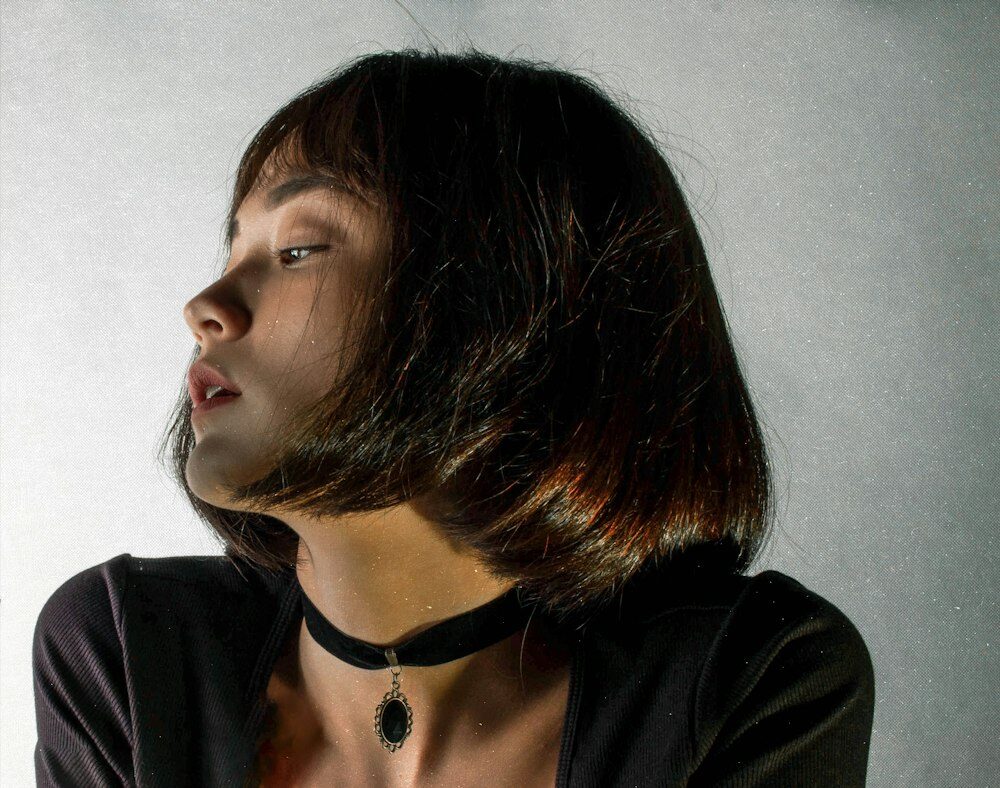 Woman with a glossy, dark shoulder-length cut